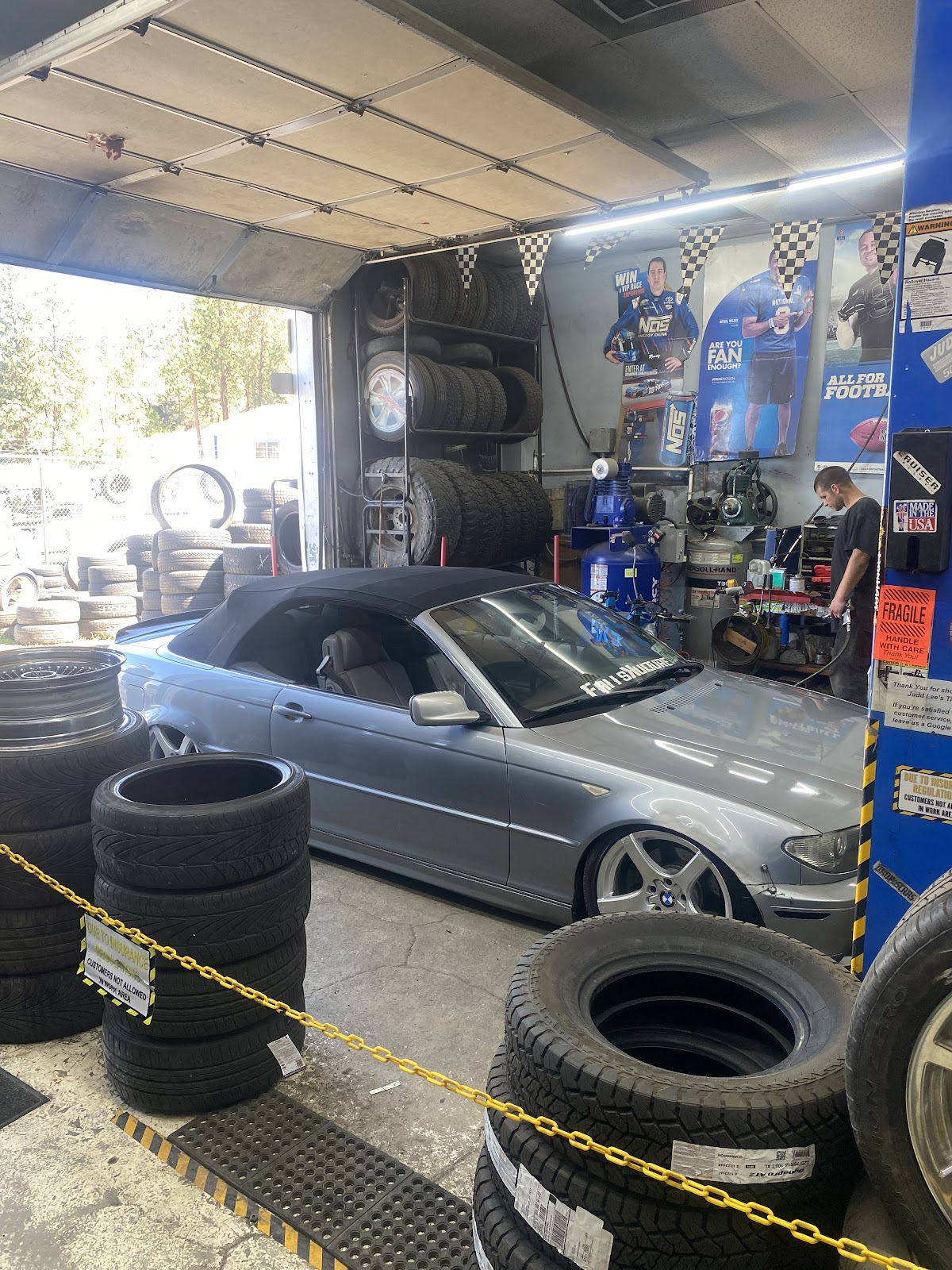 A tech at work inside the Judd Lee's Tire shop bay