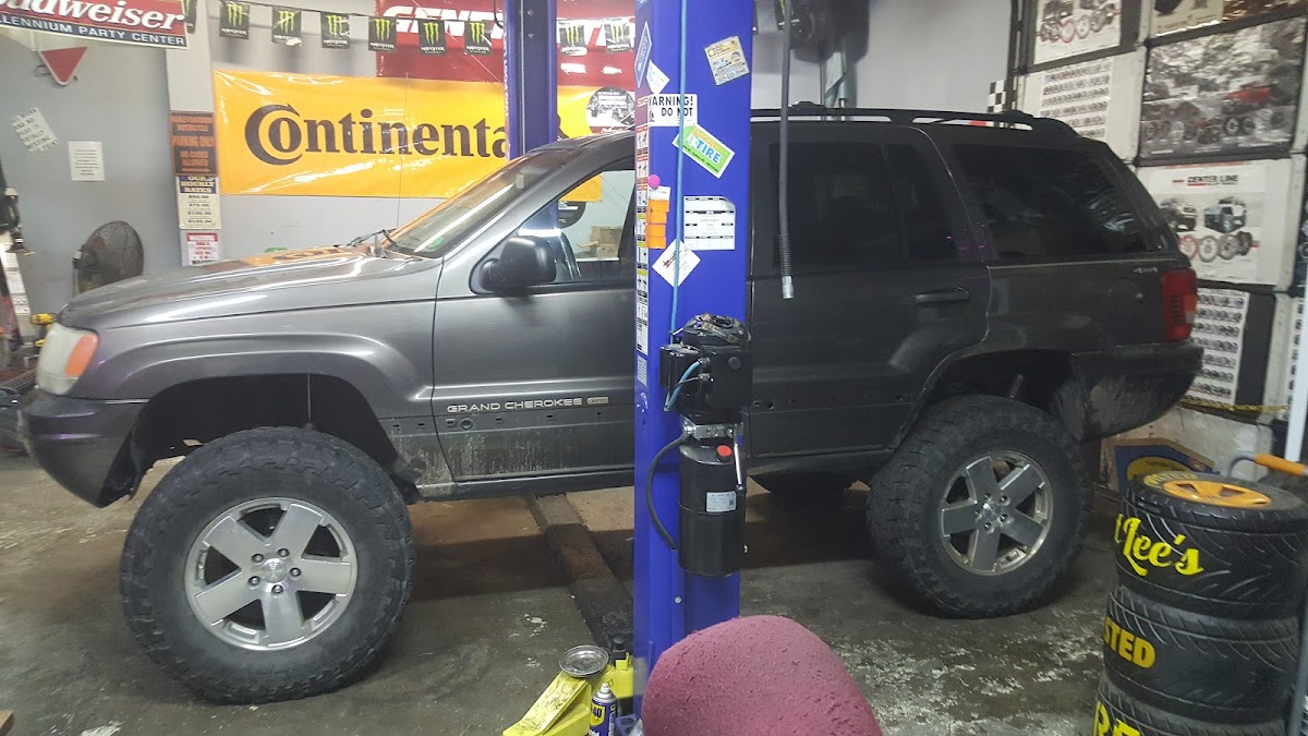 A Jeep Grand Cherokee up on the lift at Judd Lee's Tire